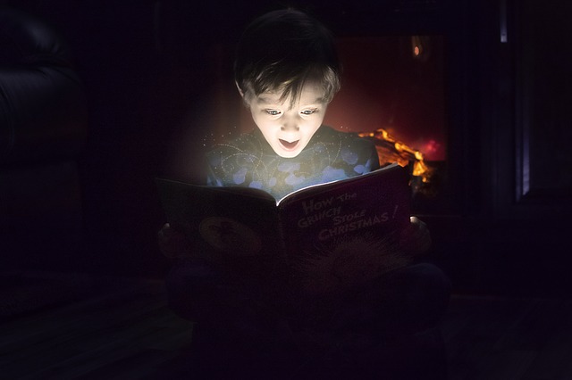 enfant qui lit dans le noir